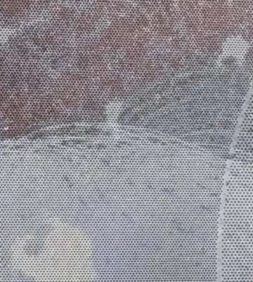 Close-up of stainless steel filter media showing partially cleaned and contaminated areas.