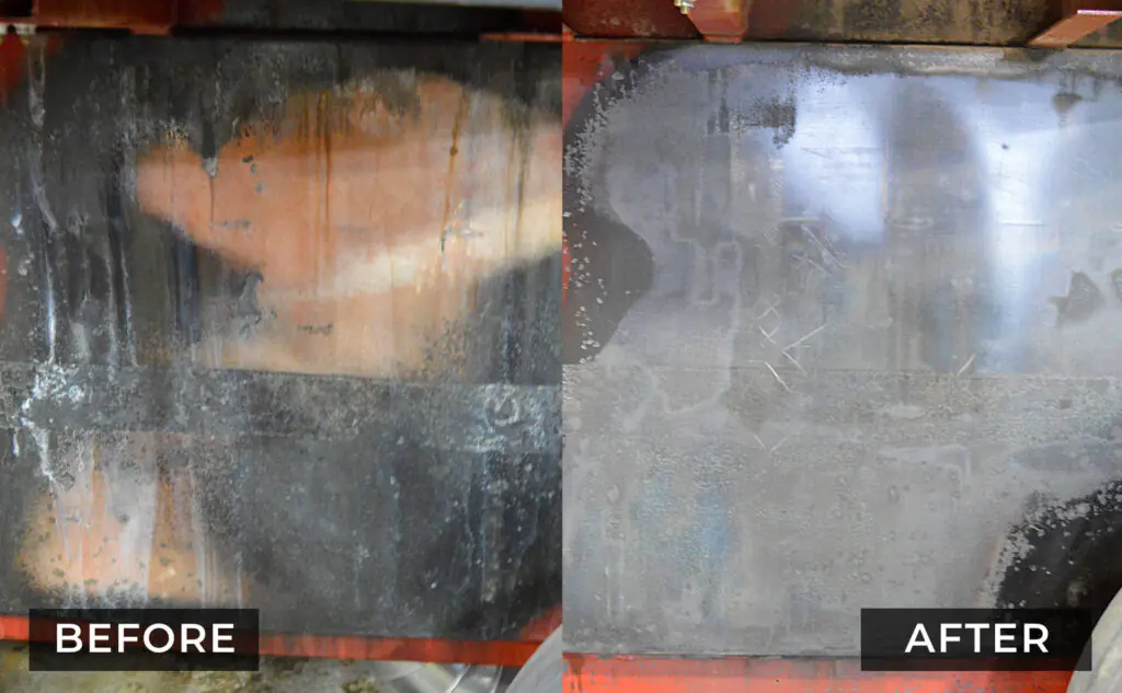 Comparison of heavy soot removed from industrial equipment, revealing the underlying metal surface.