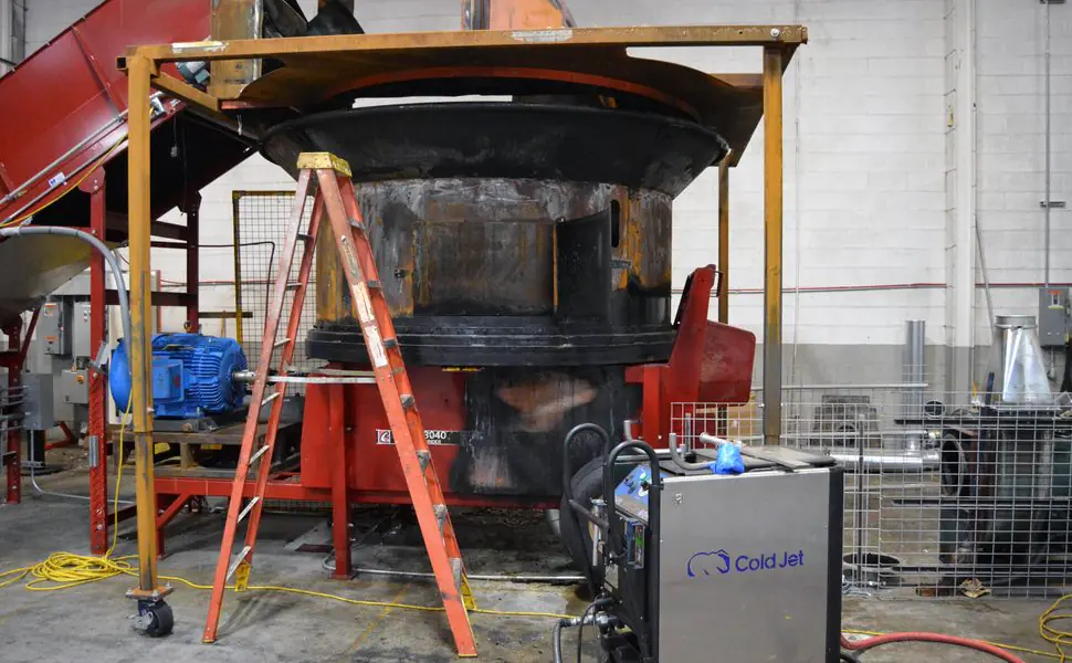 Large red industrial hay grinder with ladder and dry ice blasting equipment positioned for fire-remediation work.
